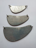 Three metal fishing rudders of different sizes on a gray background